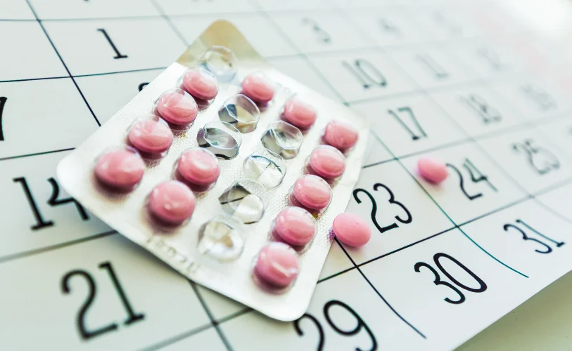 Medication blister packs arranged on a calendar