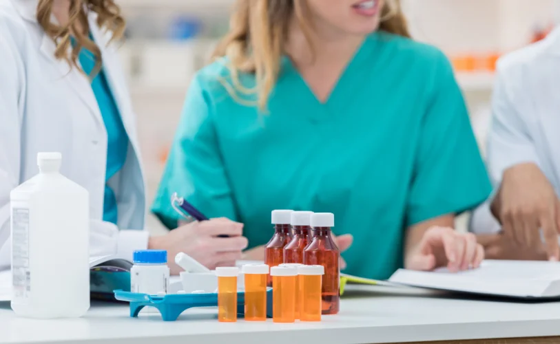 Healthcare professionals reviewing medications and notes