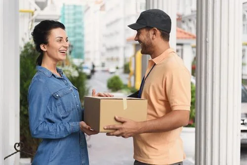 A delivery driver handing a package to a customer